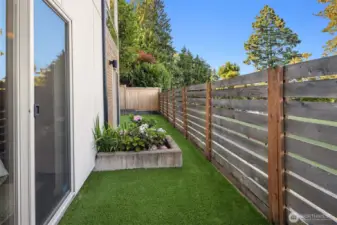 Fully fenced back yard with astroturf