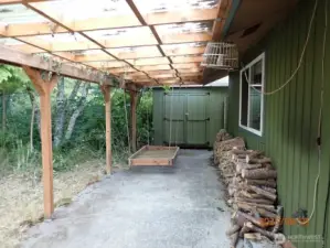 Back patio with storage shed at end