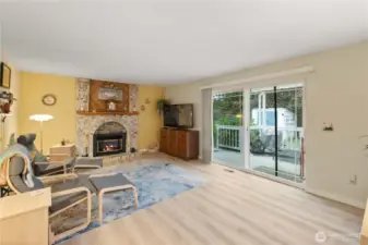 The spacious family room off of the kitchen offers the perfect place to gather and relax, featuring a cozy gas fireplace. The sliding glass door brings in the natural light from outdoors and provides easy access to the deck.