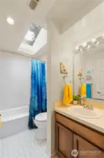The main upstairs bath feels light & bright with the overhead skylight.  The bathtub/shower was upgraded in 2017 and still looks fresh & new. Toilet was replaced in 2025.
