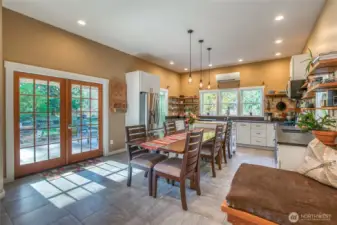 French doors off the kitchen and dining area open to a covered patio —perfect for indoor-outdoor entertaining.