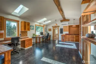 Bright and versatile upper-level space with skylights, custom wood finishes, and a built-in sink. Currently used as an office, this area offers endless possibilities for a studio, craft room, yoga, or creative workspace.