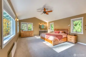 Spacious primary bedroom with a convenient sink vanity.