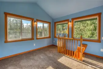 Cozy bonus room at the top of the home offers flexible space for work or relaxation.