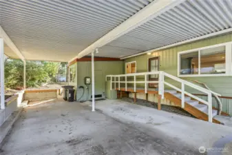 You'll love the additional storage, and extensive carport space. Pathway to backyard is at back of carport.
