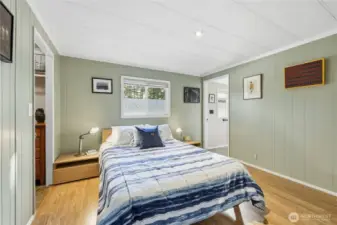 Primary bedroom with walk-in closet on the left, and ensuite with shower on the right.