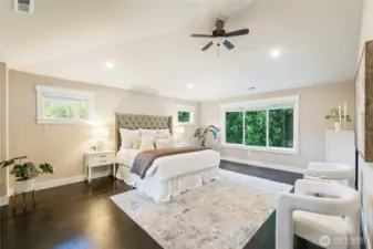 Primary suite with vaulted ceilings overlooking the backyard & greenbelct