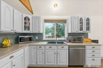Enjoy the view at the kitchen sink. Updated kitchen with stainless appliances.