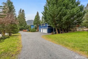 Gravel driveway leads you down to the garage/shop/DADU and main house.