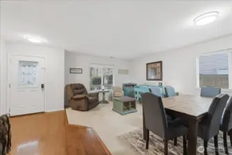 Dining and living room view towards the front door from the kitchen.