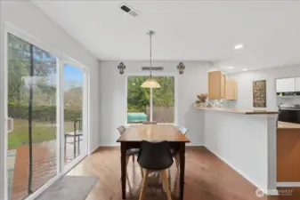 Casual dining area just off the kitchen and also features an eating bar.