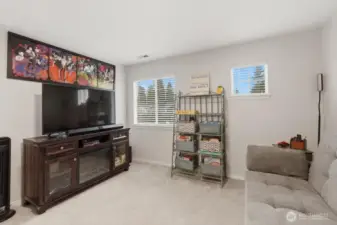 Lofted bonus room at the top of the stairs.