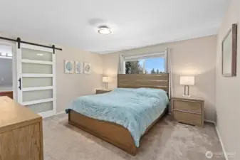 The primary bedroom with the newer barn door into the primary bath.  Very functional!