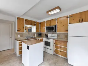 Kitchen features pine cabinets
