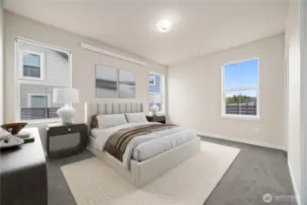 The primary bedroom is spacious and looks toward the rear yard.