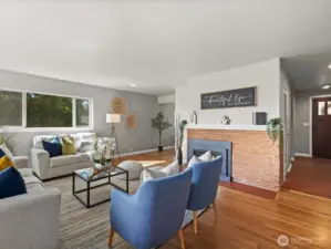 Cozy main floor Livingroom with natural gas fireplace and hardwood flooring