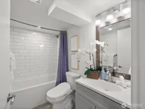 Lower level full bathroom with deep tub and shower head.