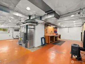 Another view of lower level workshop with built in work bench