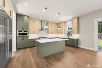 Stylish and functional, this kitchen features designer two-tone cabinets, sleek pendant lighting, and a spacious island with quartz countertops. Premium stainless appliances, ample prep space, and backyard views make it the heart of the home.