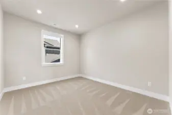 Versatile secondary bedroom featuring soft carpet, neutral paint, and a bright window—perfect as a guest space, home office, or creative studio.