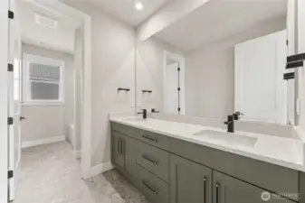 Stylish full bathroom featuring dual sinks, matte black hardware, quartz countertops, and a separate water closet with a tub/shower combo.