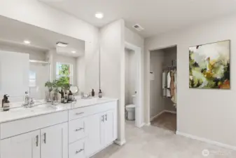 Primary bathroom with double vanity and quartz countertops. Photo is representational. Actual home is under construction. Colors, materials, and features may vary. See site agent for details.