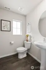Main floor half bathroom. Photo is representational. Actual home is under construction. Colors, materials, and features may vary. See site agent for details.
