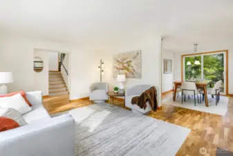 Glimpse at the unique side-oriented staircase & dining room from living area