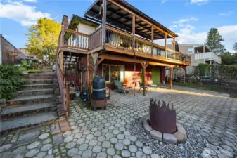 Covered deck above, covered patio below, and plenty of open air space.  This is a really large yard, full of fun and spirit.