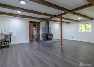 Open living area with woodstove and laundry hook ups