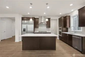 Well-appointed kitchen with upgraded appliances package, Photo is representational. Actual home is under construction and materials, colors, and finishes will vary. See site agent for details.