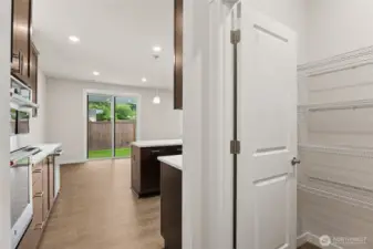 Large walk-in pantry and mud room area as you enter the home from your 2-car garage. Actual home is under construction and materials, colors, and finishes will vary. See site agent for details.