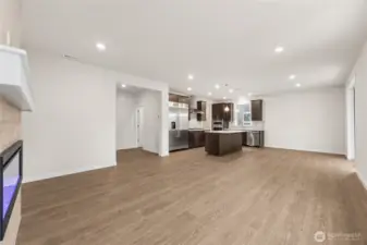 Overlooking at the kitchen from the great room. Actual home is under construction and materials, colors, and finishes will vary. See site agent for details.