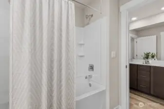 Tub/shower in the 2nd level full bath. Photo is representational. Actual home is under construction and materials, colors, and finishes will vary. See site agent for details.