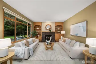 Inviting family room with a fireplace and custom built-in shelving