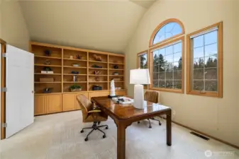 Expansive office featuring custom built-ins, offering flexibility as a bonus or media room