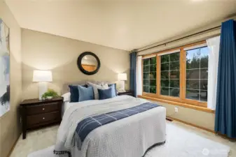Upstairs bedroom with pleasant neighborhood views, offering natural light and a comfortable setting
