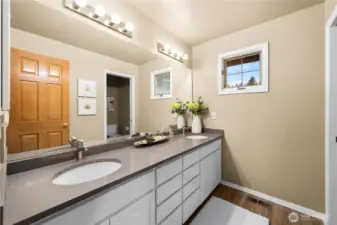 Updated hall bath with a double vanity for added functionality and comfort