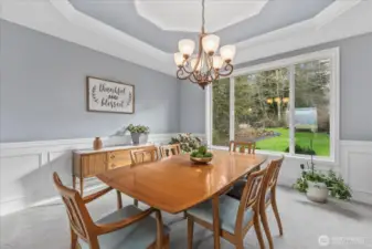 Formal Dining room overlooking the lush backyard. This room represents the true wall color thru house