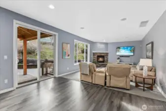 Extra large family room with built in speakers, gas fireplace and door to the covered patio and Backyard