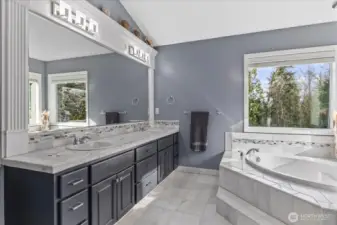 Primary suite, luxurious bathroom complete with marble floors