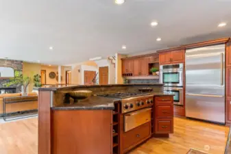 Outfitted with top-of-the-line stainless steel appliances, a six-burner gas range, and an oversized island perfect for meal prep.