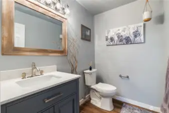 Powder room for main floor use (next to 3rd bedroom).New, modern vanity and lighting installed.