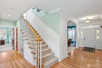 Gracious front entry hall with newly refinished hardwood floors