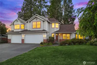 House is set back from the street with a large lawn and garden, making the interior feel very private