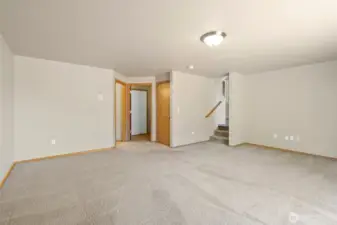 Family room, looking towards garage entry, laundry room and 1/2 bath