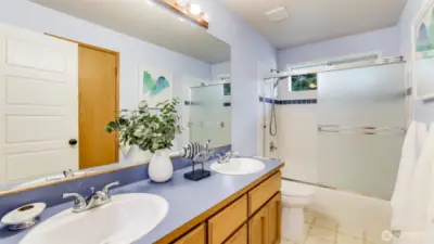 The full hall bath has spacious feeling for multiple users of the bath.