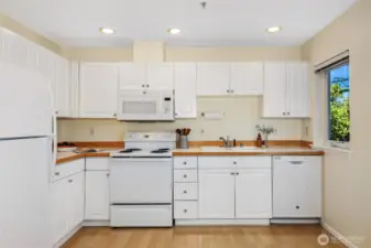 Ample counter space and cabinets in this bright kitchen
