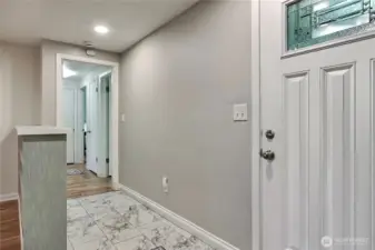 As you enter, you will find lovely tile flooring in the entry, and to your right the hallway to beds and bath.