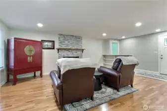 View of the living room toward entry and hall, loving those built-in bookcases.